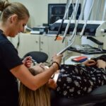 a general dentist in Cinnaminson, NJ, treats a patient
