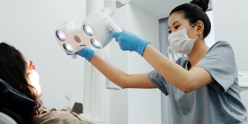 a dentist in Cinnaminson, NJ, treats a patient for cavities