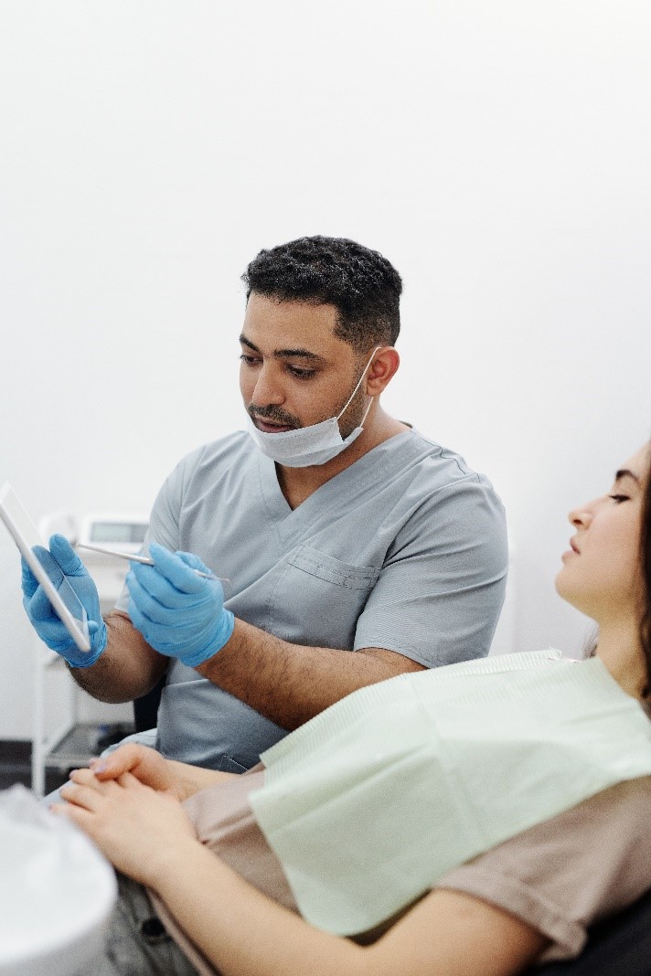 a general dentist in Cinnaminson, NJ, checks a patient