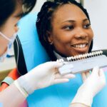 A dentist looking at dental bridges to match patient’s teeth