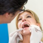 Dentist examines a patient