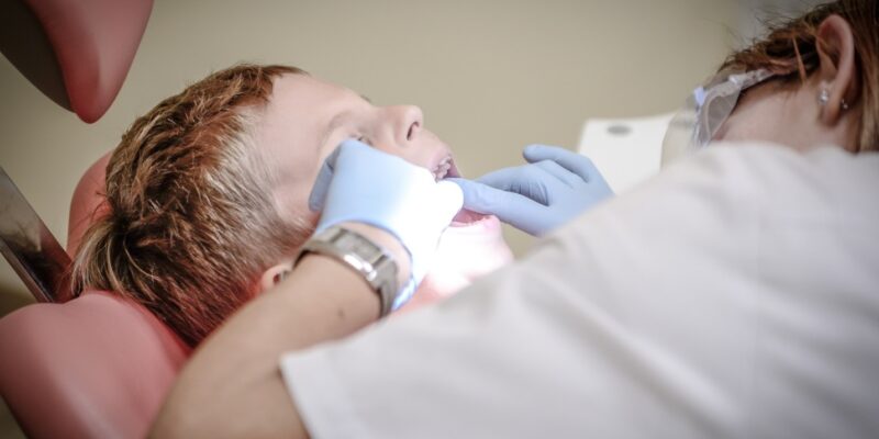 Dentist performing a root canal on a patient