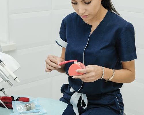 A cosmetic dentist cleaning dentures