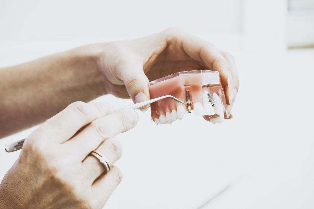 A dentist holding dentures