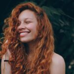 A girl smiling widely after getting affordable dental implants in Cinnaminson, NJ