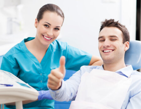Man giving thumbs up at dentist office